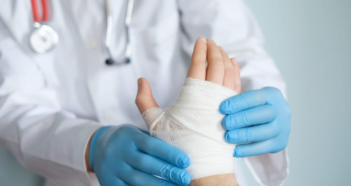 Doctor Treating Hand Injury