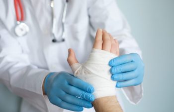 Doctor Treating Hand Injury