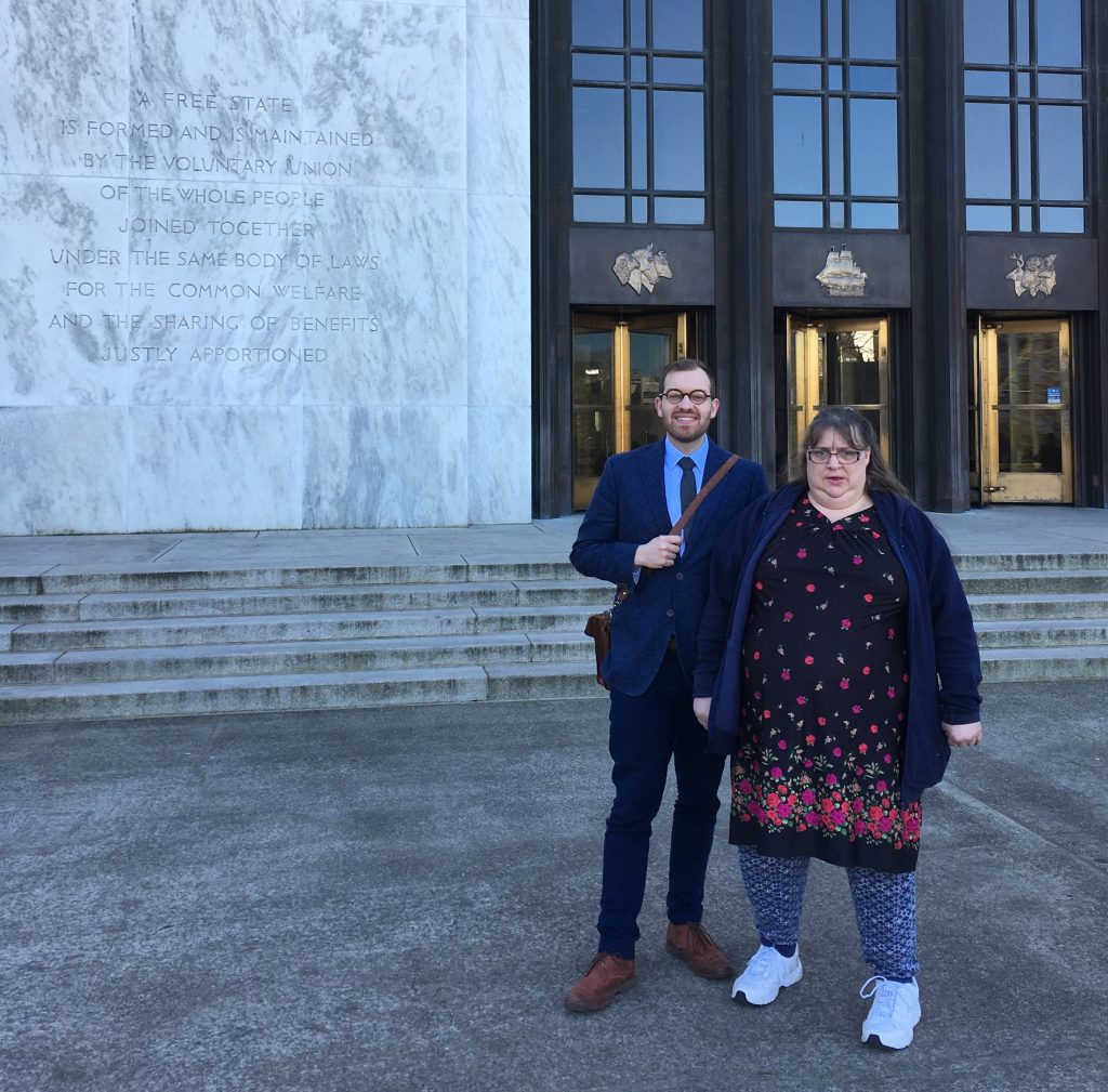 Attorney Scott Sell and Tina Martin standing outside the Oregon State Capitol, preparing to testify in defense of legal protections for Oregonians living with disabilities.