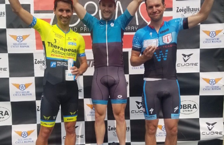 Chris Thomas standing on the podium for the Red Line Criterium on Swan Island in Portland, OR.