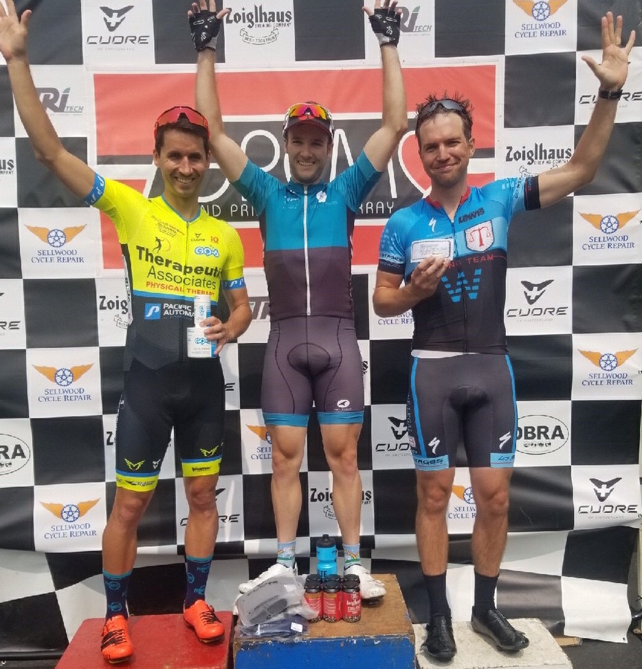 Chris Thomas standing on the podium for the Red Line Criterium on Swan Island in Portland, OR.