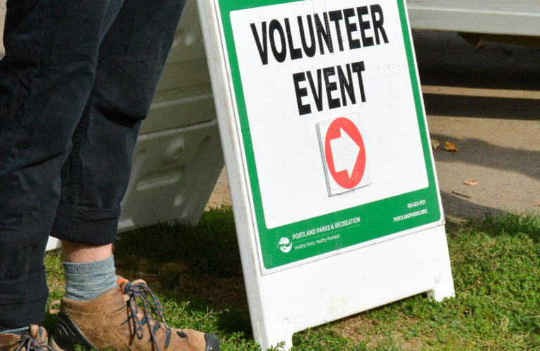 Sign saying "volunteer event"; this sign was posted at Sellwood Park during Thomas, Coon, Newton & Frost's recent Community Service Day with Portland Parks and Recreation